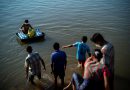 Fleeing violence in Myanmar, thousands camp along Thai border river